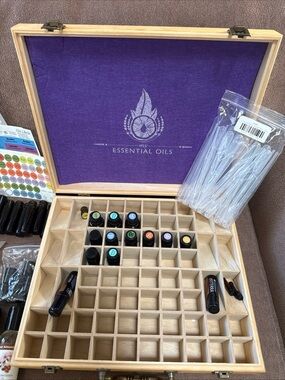 DōTerra essential oil box with 13 new/opened exp oils with extra bottles/info.